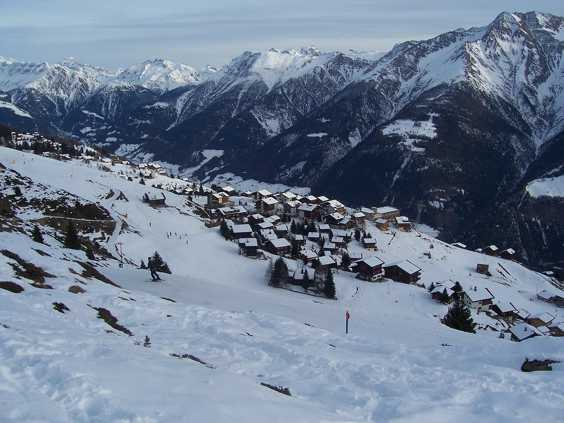 Snowy slopes and mountain village in Aletsch Arena