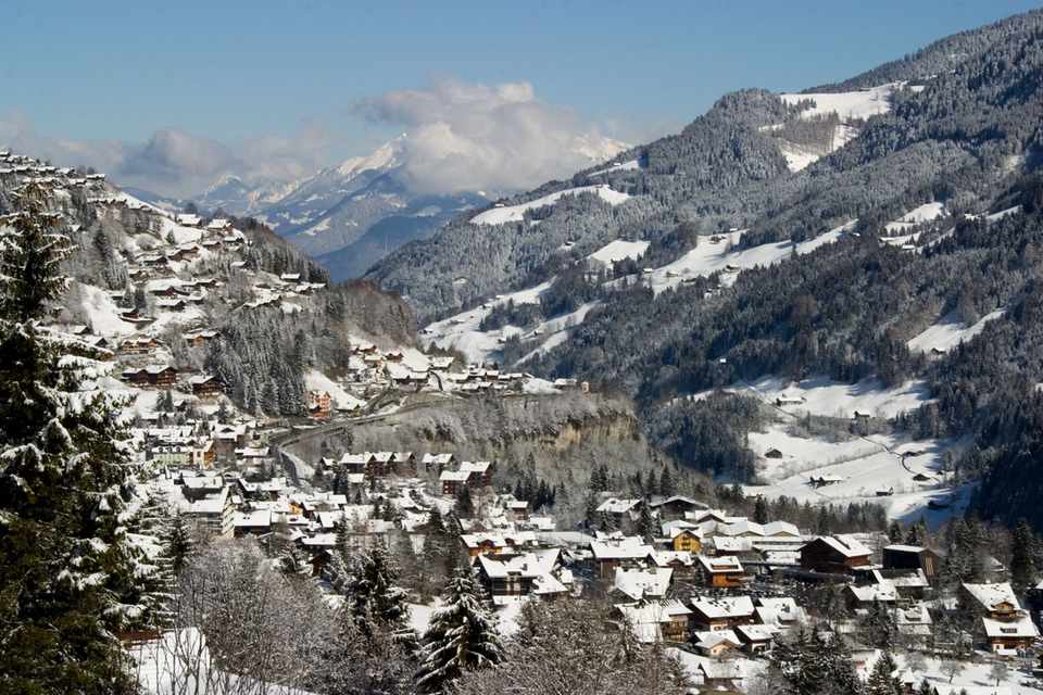 Snow-covered village and mountains in Les Portes du Soleil