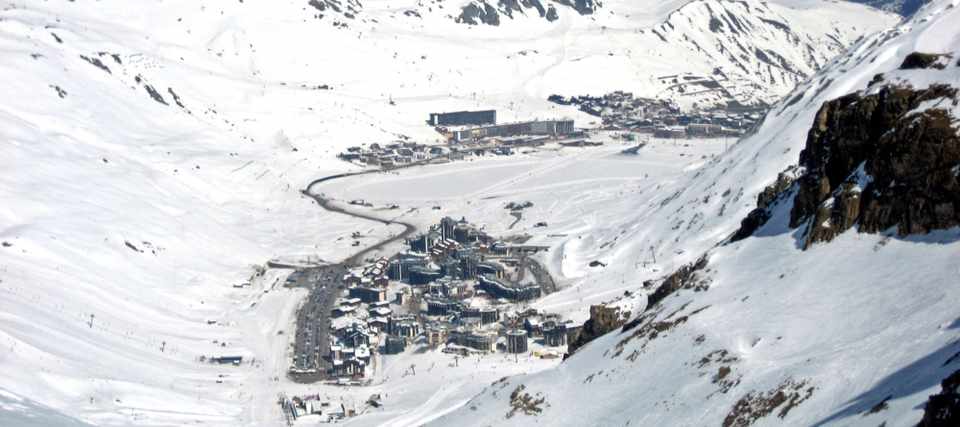 Tignes Val Claret and Tignes le Lac surrounded by snow-covered slopes, seen from Grande Motte